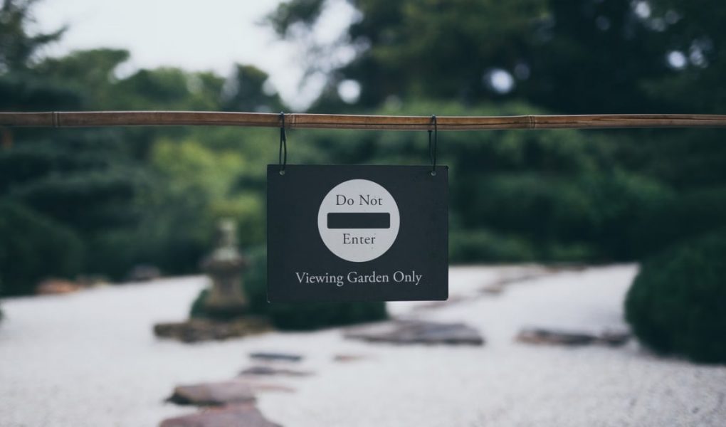 Peaceful garden scene with 'Do Not Enter' sign, promoting serenity and exclusivity.
