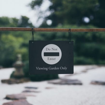 Peaceful garden scene with 'Do Not Enter' sign, promoting serenity and exclusivity.