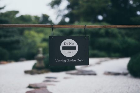 Peaceful garden scene with 'Do Not Enter' sign, promoting serenity and exclusivity.